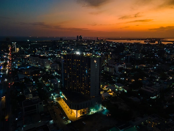 Lagos skyline at dusk with illuminated high-rise tower and city lights